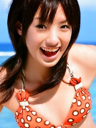 Akina Minami in colorful bath suits plays with big ball